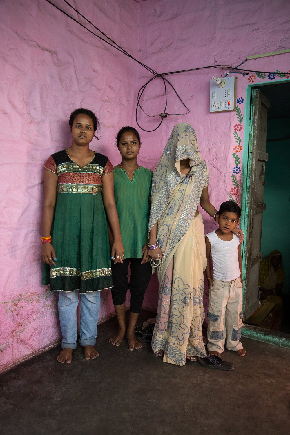 Sunita Sarsar, 22, poses for a photo veiled, with her son Piyush and her two sisters-in-law. In poor areas of northeren India, it is a Hindu tradition for a woman to hide her face to the elderly men in her husband’s family. It is regarded as a sign of respect.