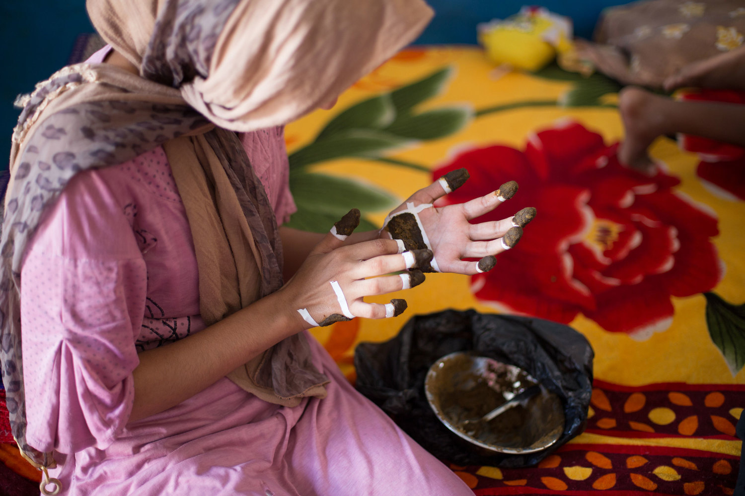  Noha applies henna to her hands in preparation for her engagement, on Seheil Island. 