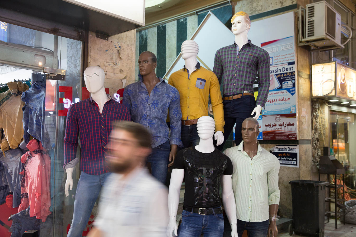  A man passes by a clothing shop in Little Damascus in 6 October City, Egypt. Syrians are famous across the Middle East for their trade in fabrics. 